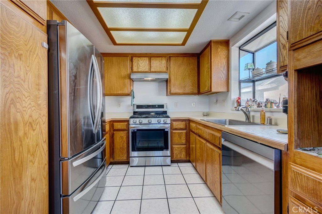 26489 Bluewater Road Helendale, CA 92342 - Photo 13 of 62 a kitchen with stainless steel appliances granite countertop a refrigerator and a stove