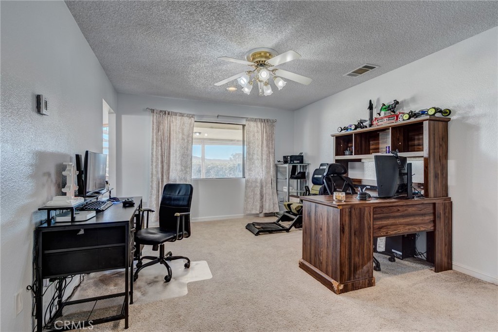 26489 Bluewater Road Helendale, CA 92342 - Photo 18 of 62 a view of a workspace with furniture and a window