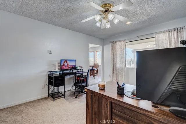 a view of a livingroom with furniture flat screen tv and hallway