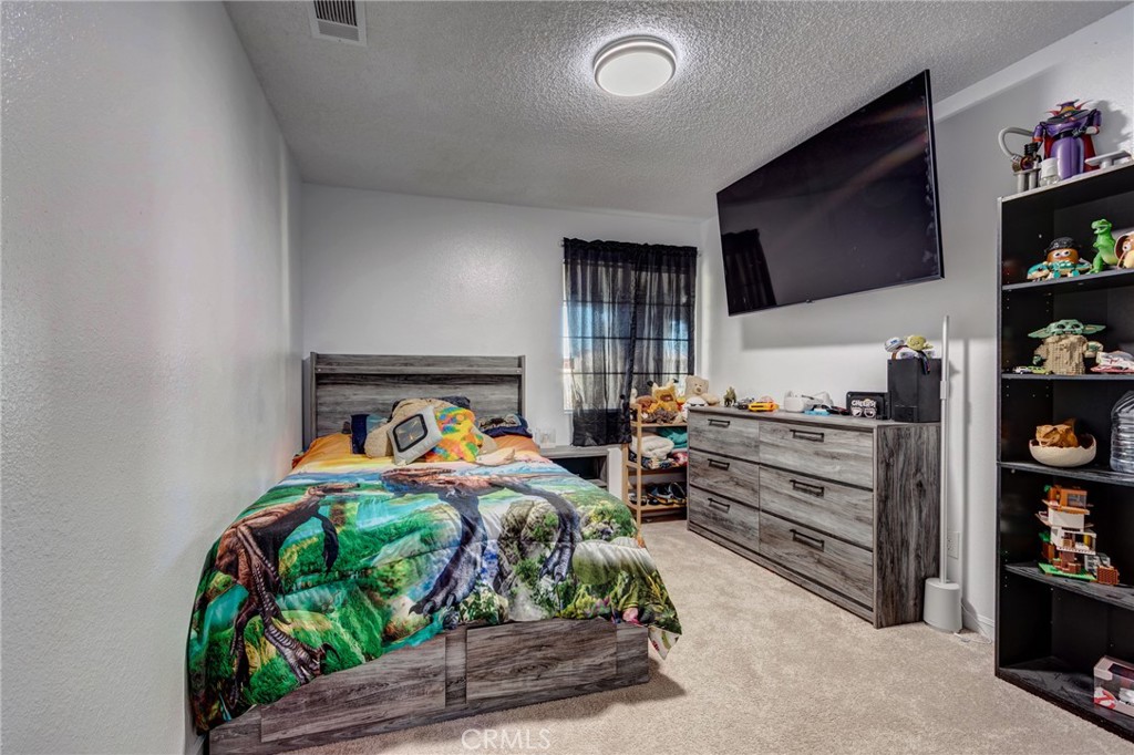 26489 Bluewater Road Helendale, CA 92342 - Photo 20 of 62 a bedroom with furniture and a flat screen tv