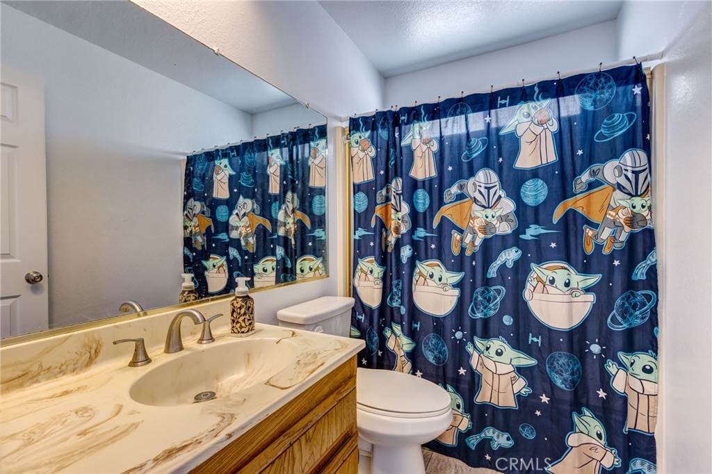 26489 Bluewater Road Helendale, CA 92342 - Photo 21 of 62 a bathroom with a sink mirror vanity and toilet
