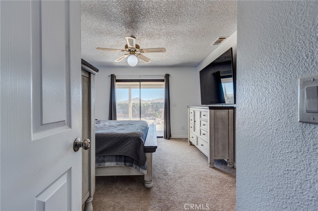 26489 Bluewater Road Helendale, CA 92342 - Photo 22 of 62 a view of a livingroom with furniture flat screen tv and hallway