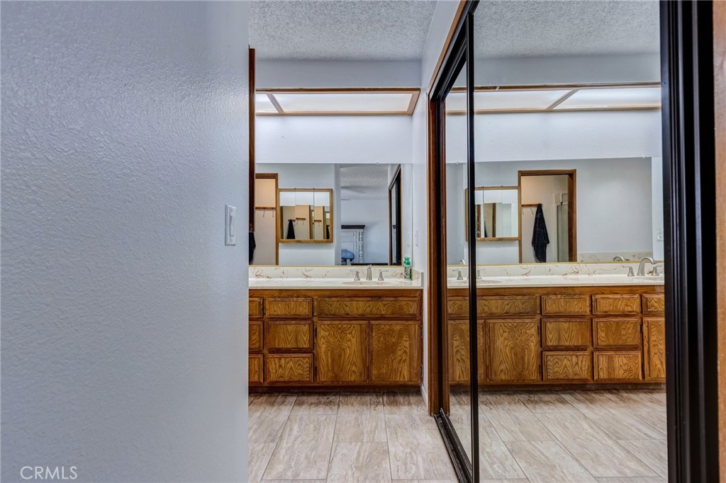 26489 Bluewater Road Helendale, CA 92342 - Photo 25 of 62 a spacious bathroom with a double vanity sink and a mirror