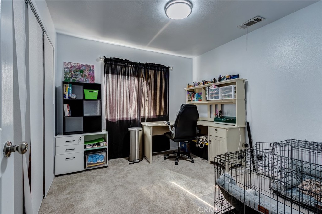 26489 Bluewater Road Helendale, CA 92342 - Photo 32 of 62 a view of a workspace with furniture and toys