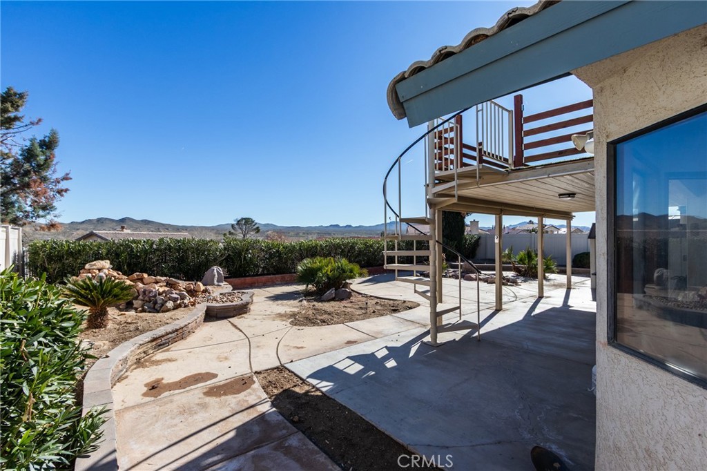 26489 Bluewater Road Helendale, CA 92342 - Photo 41 of 62 a view of a patio with a table and chairs under an umbrella