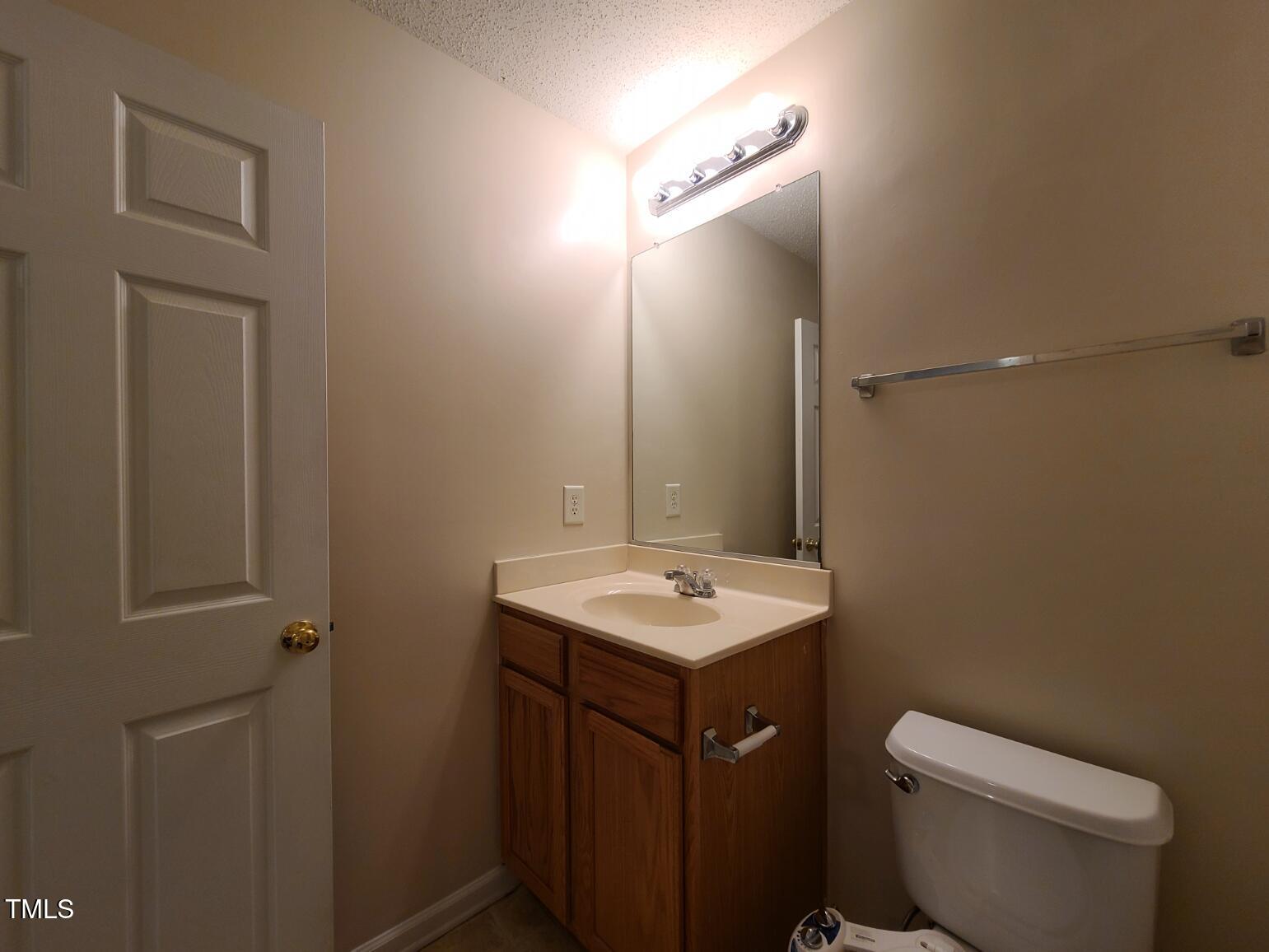 116 Hidden Springs Drive Durham, NC 27703 - Photo 16 of 19 a bathroom with a toilet sink and mirror