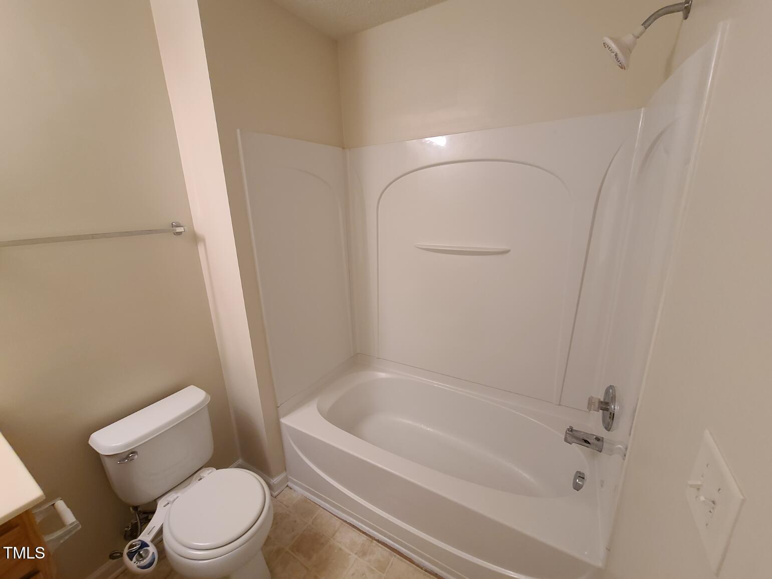 116 Hidden Springs Drive Durham, NC 27703 - Photo 17 of 19 a white toilet sitting next to a bath tub