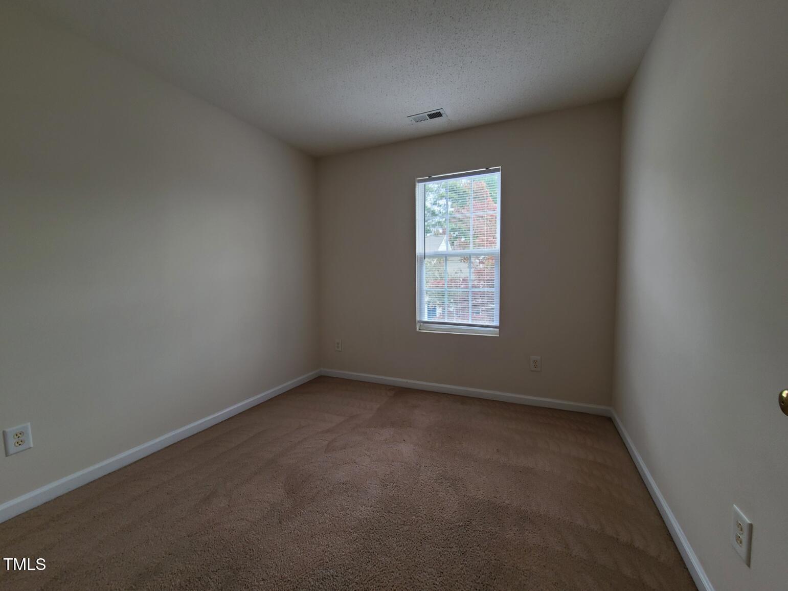 116 Hidden Springs Drive Durham, NC 27703 - Photo 18 of 19 an empty room with a window