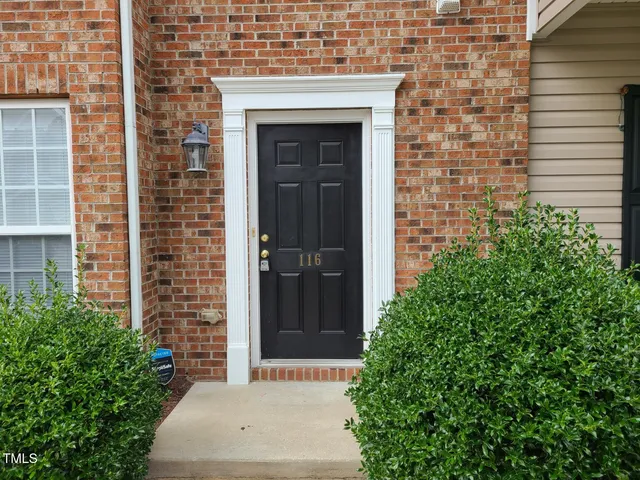 an entrance to house with yard