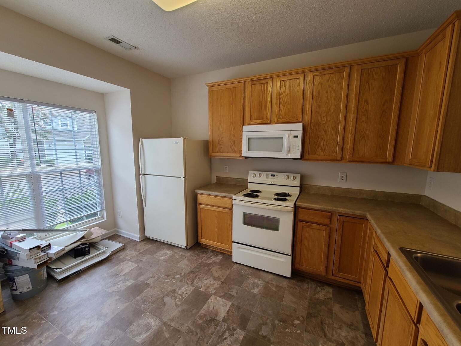 116 Hidden Springs Drive Durham, NC 27703 - Photo 4 of 19 a kitchen with a stove a refrigerator and a sink