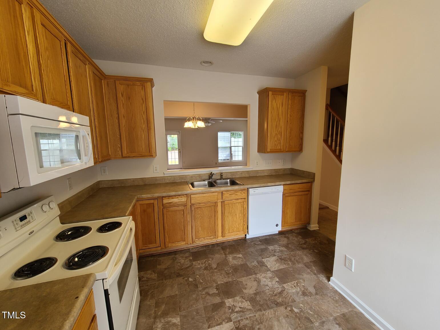 116 Hidden Springs Drive Durham, NC 27703 - Photo 5 of 19 a kitchen with a sink a stove and cabinets