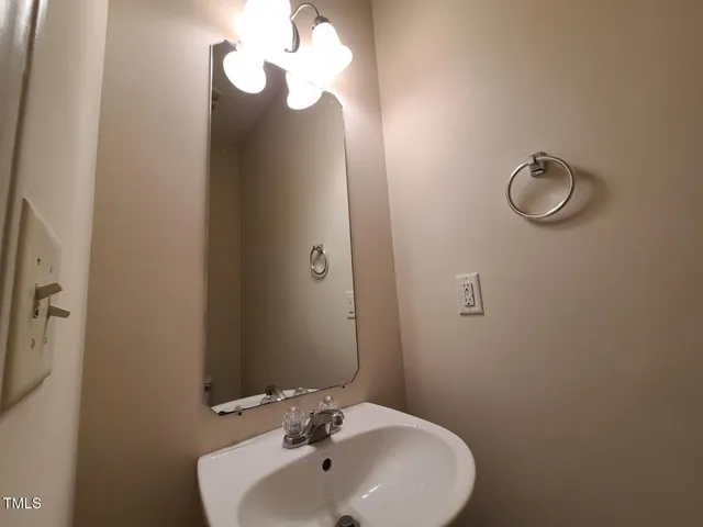 a bathroom with a sink and mirror
