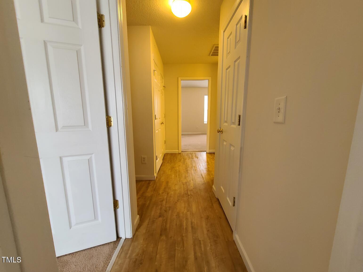 116 Hidden Springs Drive Durham, NC 27703 - Photo 10 of 19 a view of a hallway with wooden floor