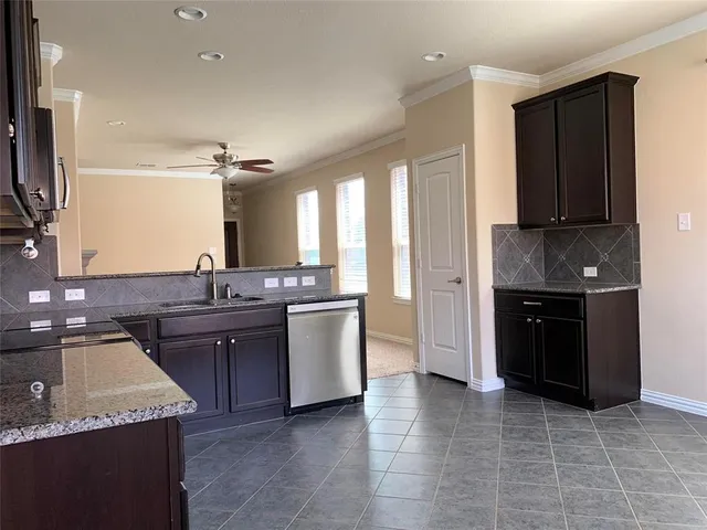 a kitchen with a sink stove and cabinets