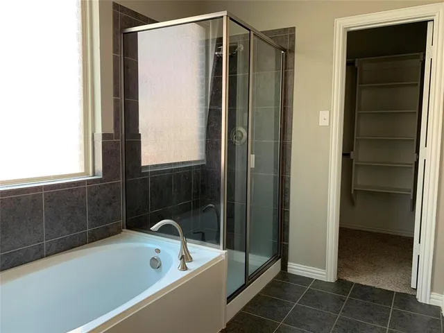 a bathroom with a tub and a shower