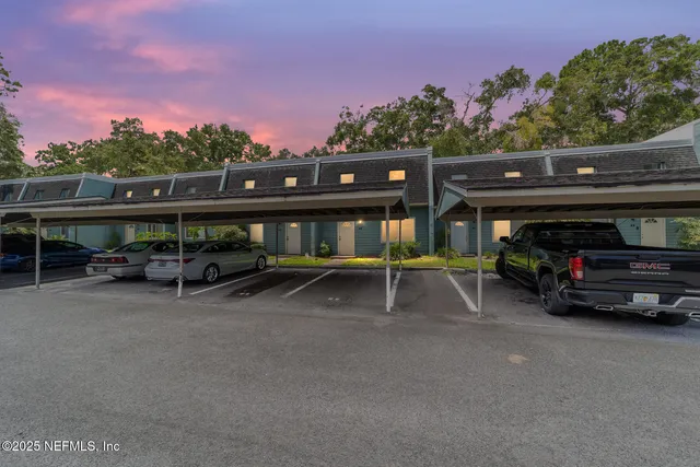 a view of house with outdoor space and car parked