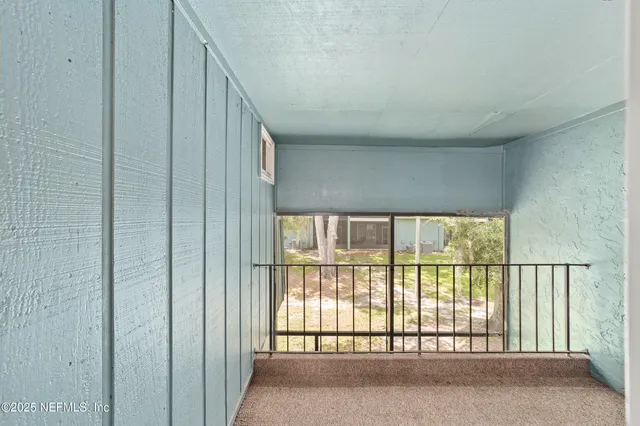 a view of an empty room with a large window