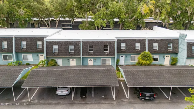 an aerial view of a house with a garden and lake view