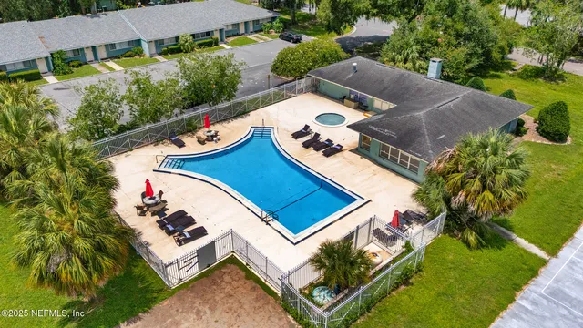 an aerial view of a house with a garden and lake view