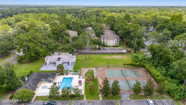 an aerial view of a house with outdoor space pool patio and lake view