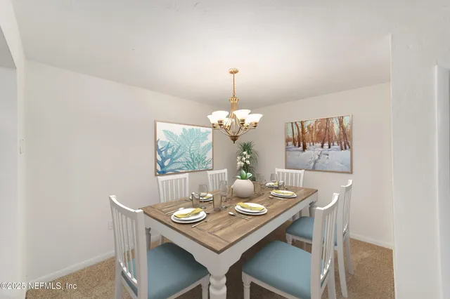 a view of a dining room that has a table and chairs