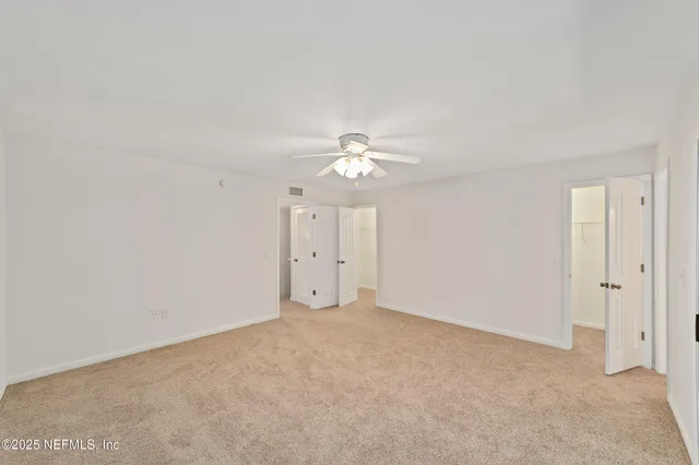a view of a patio with table and chairs and wooden fence