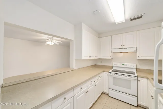 a view of white cabinets and window