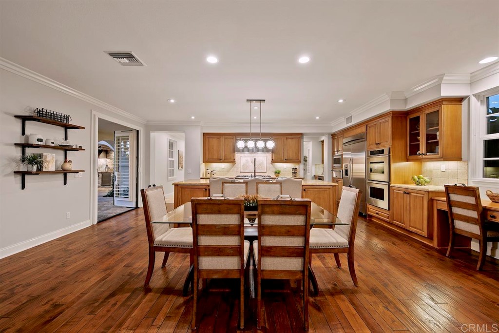 3220 Sitio Montecillo Carlsbad, CA 92009 - Photo 11 of 48 a view of a dining room with furniture and wooden floor