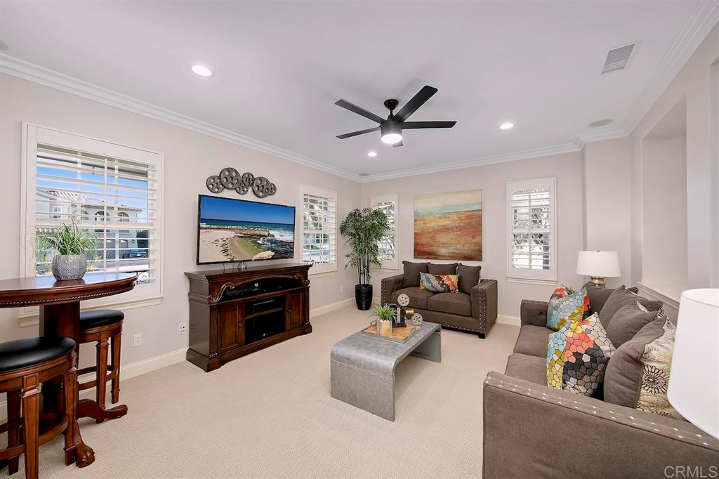 3220 Sitio Montecillo Carlsbad, CA 92009 - Photo 36 of 48 a living room with furniture and a flat screen tv
