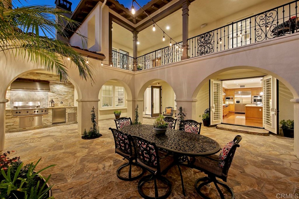 3220 Sitio Montecillo Carlsbad, CA 92009 - Photo 45 of 48 a dining room with furniture and a chandelier