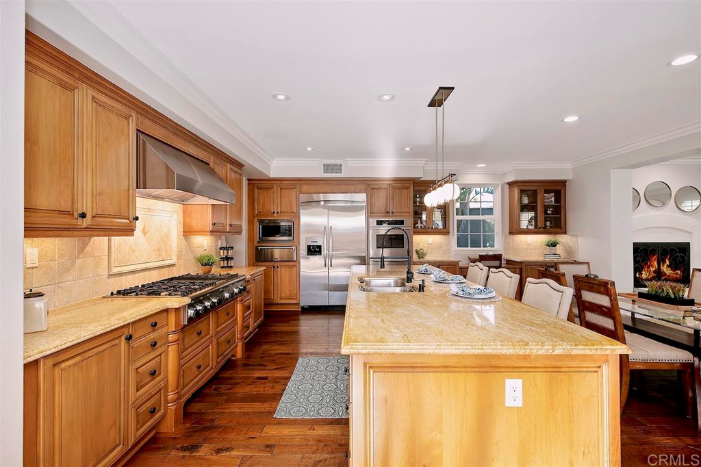 3220 Sitio Montecillo Carlsbad, CA 92009 - Photo 9 of 48 a kitchen with sink stove and cabinets