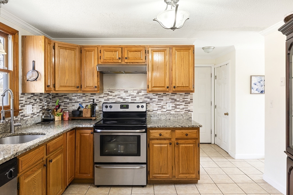 7 Overlook Avenue Haverhill, MA 01832 - Photo 8 of 32 a kitchen with stainless steel appliances a stove a sink and a refrigerator