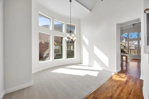 a view of a living room with a floor to ceiling window and wooden floor