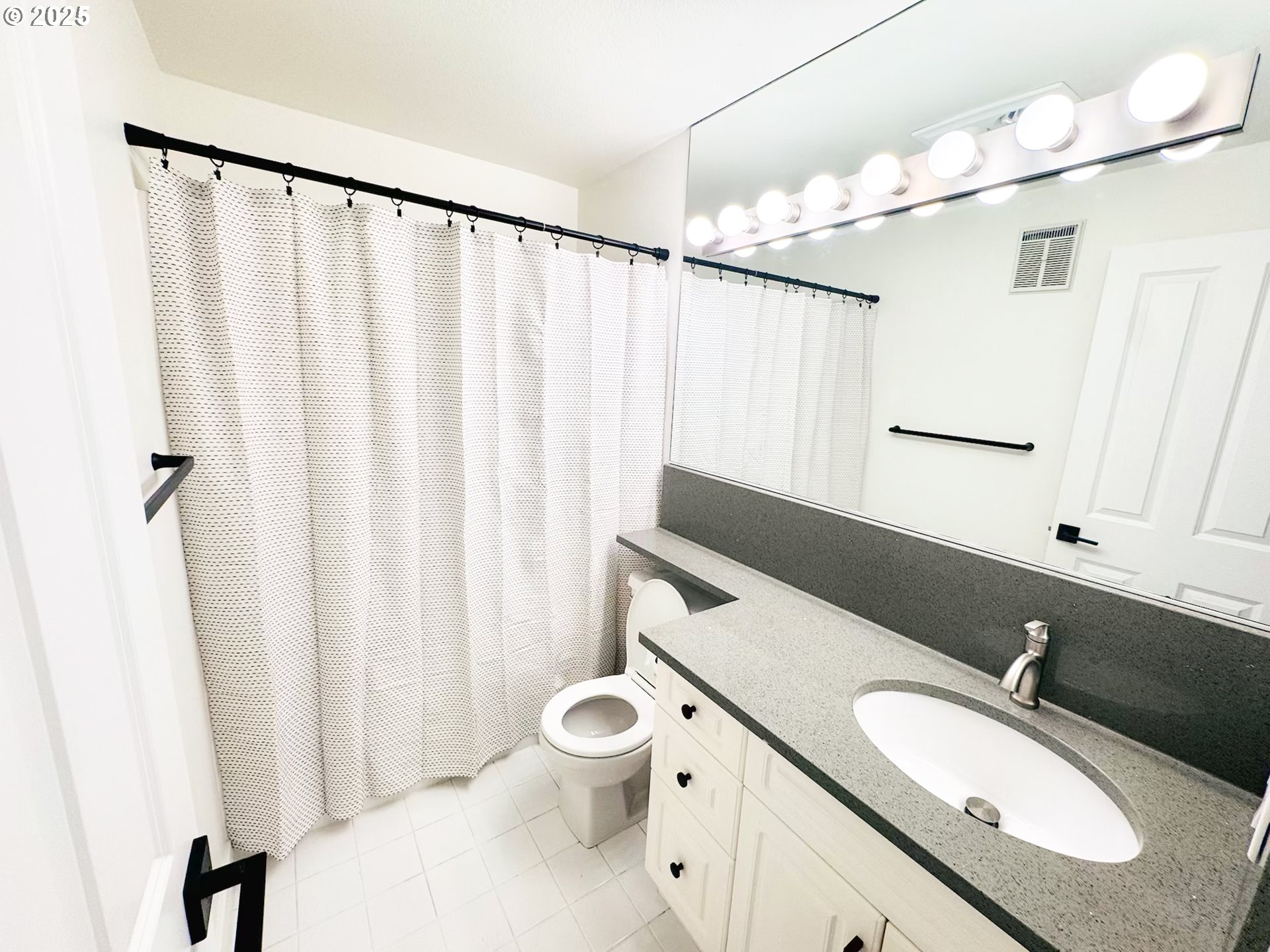 8720 Southwest Tualatin Road, Unit 315 Tualatin, OR 97062 - Photo 18 of 41 a bathroom with a granite countertop sink toilet and a mirror