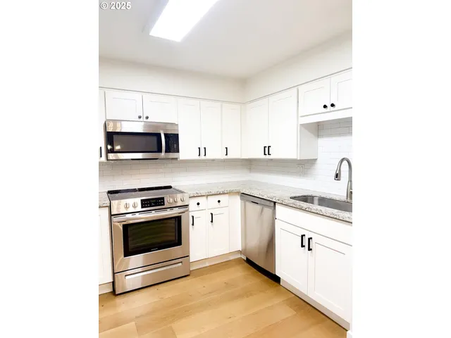 a view of a room with a ceiling fan and window