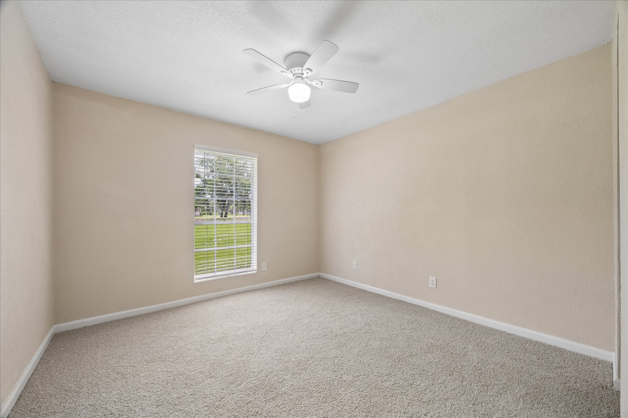 316 Rabbit Trail Lake Jackson, TX 77566 - Photo 14 of 16 an empty room with windows and fan