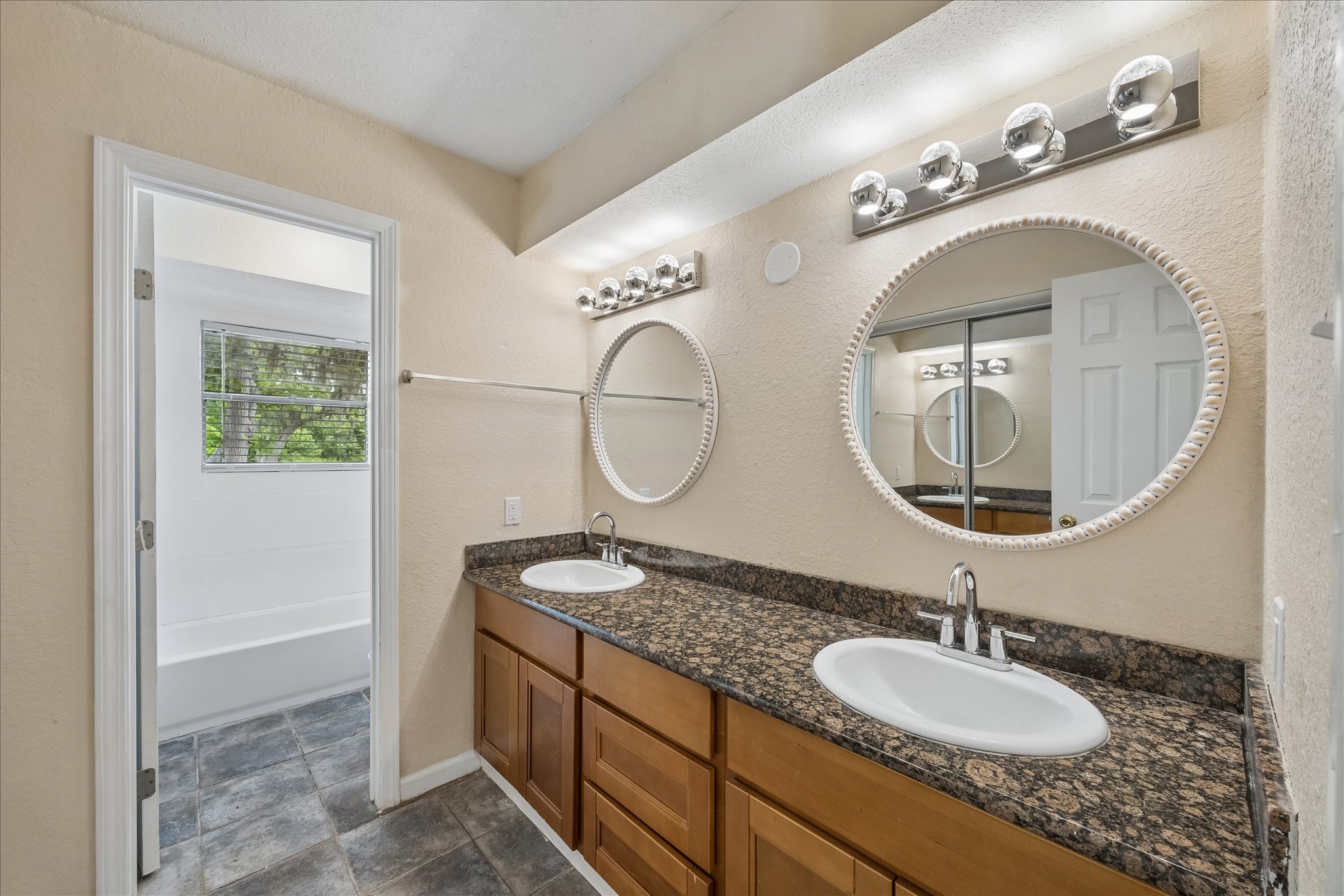 316 Rabbit Trail Lake Jackson, TX 77566 - Photo 4 of 16 a bathroom with a granite countertop double vanity sinks and a mirror