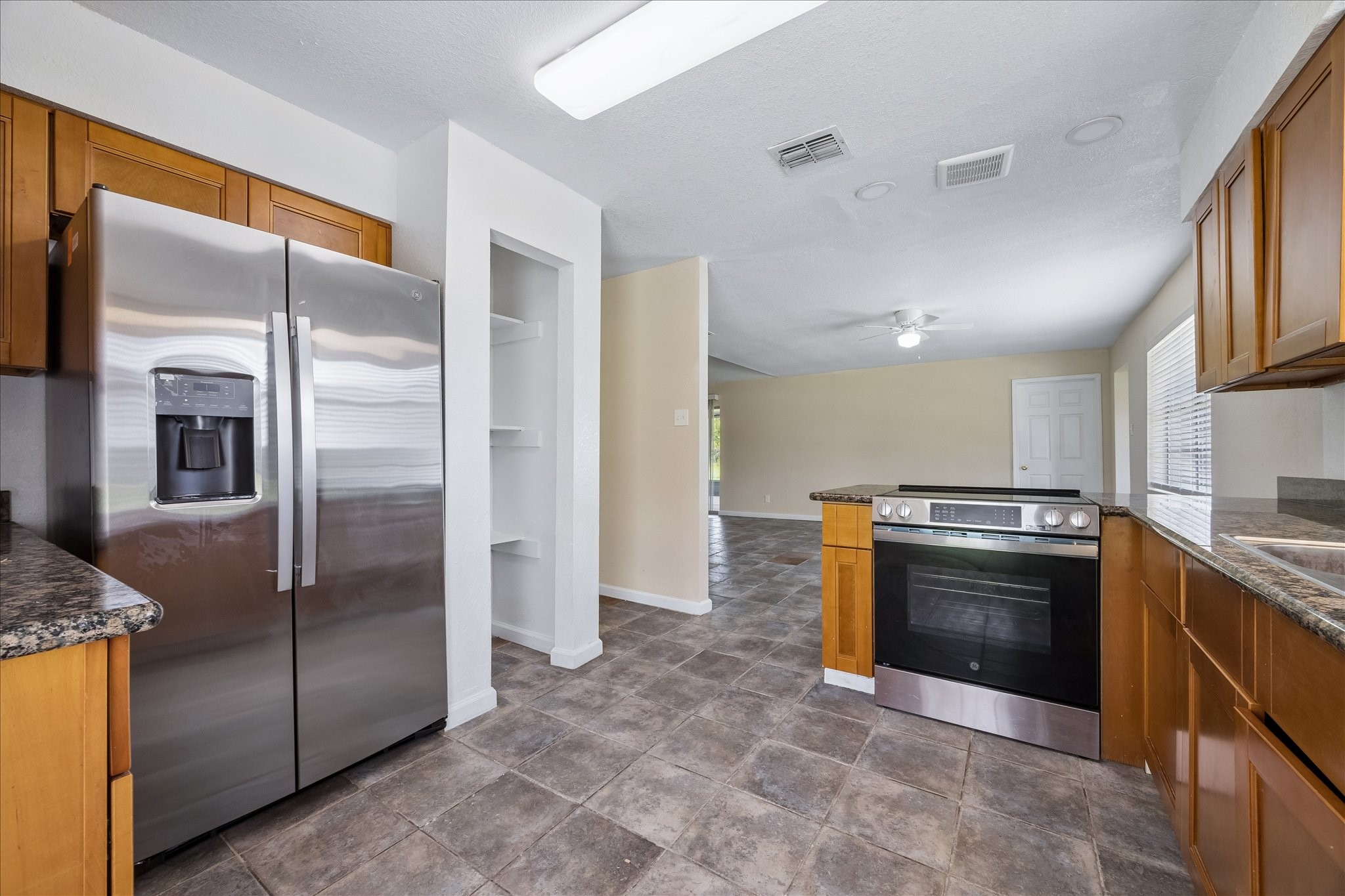 316 Rabbit Trail Lake Jackson, TX 77566 - Photo 9 of 16 a kitchen with stainless steel appliances granite countertop a refrigerator and a stove