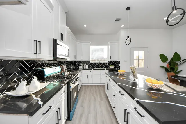 a kitchen with kitchen island granite countertop lots of counter top space