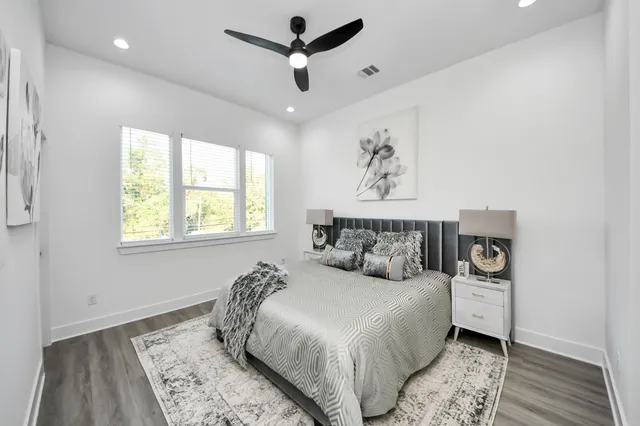 a bedroom with a large bed and a window