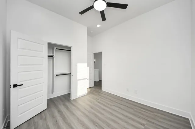 a view of empty room with wooden floor