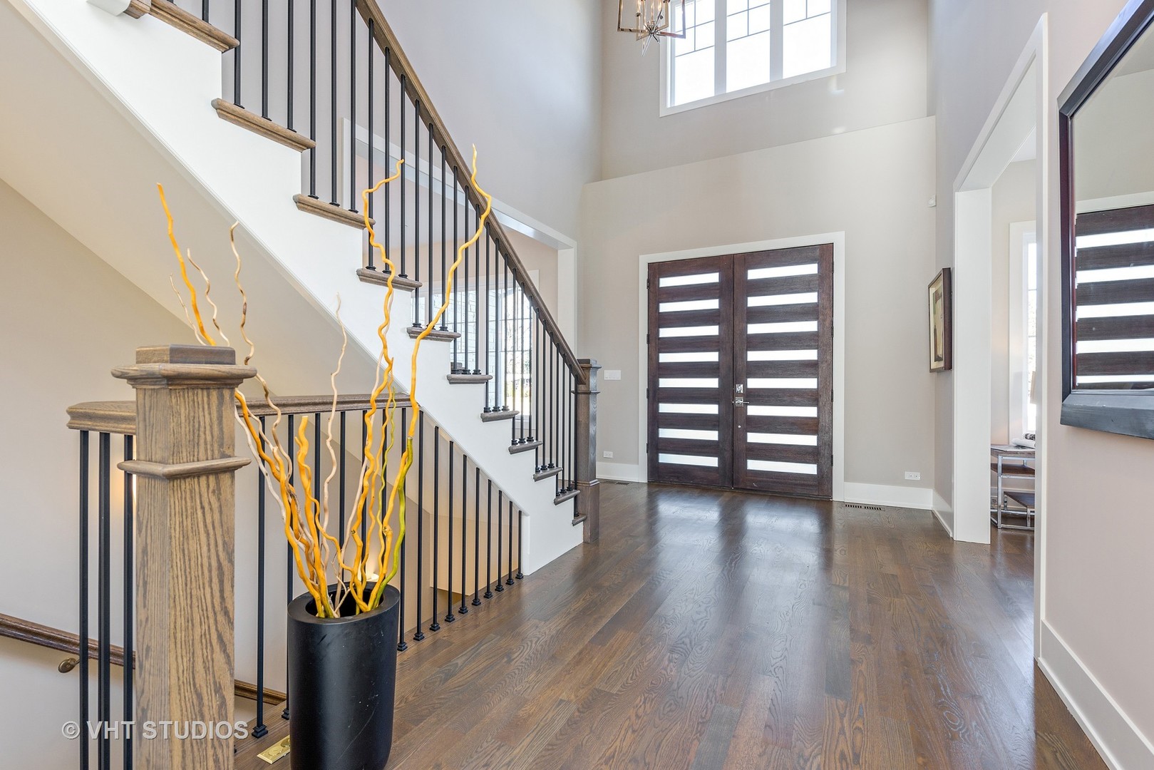 2709 Walters Avenue Northbrook, IL 60062 - Photo 3 of 33 a view of staircase with wooden floor and a window