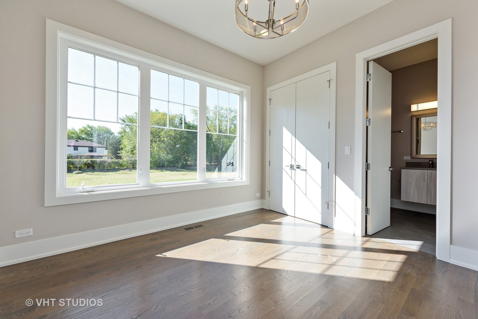 2709 Walters Avenue Northbrook, IL 60062 - Photo 25 of 33 a view of an empty room with wooden floor and a window