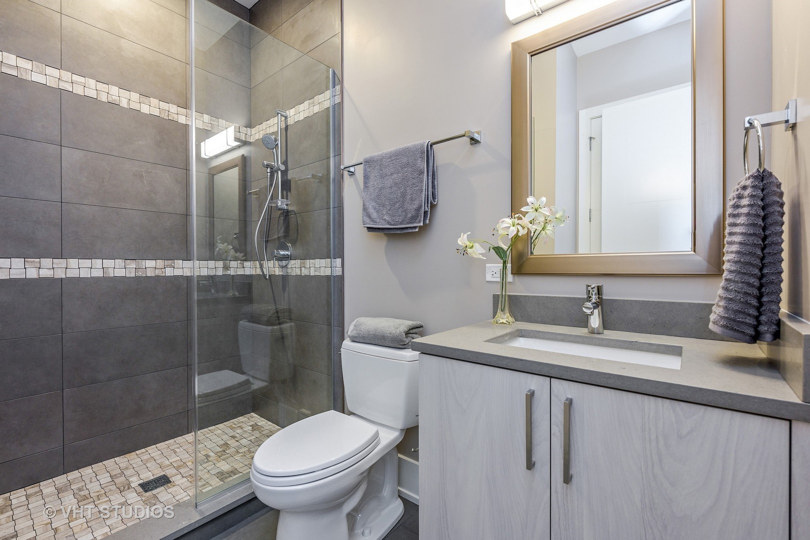 2709 Walters Avenue Northbrook, IL 60062 - Photo 26 of 33 a bathroom with a granite countertop sink toilet and shower
