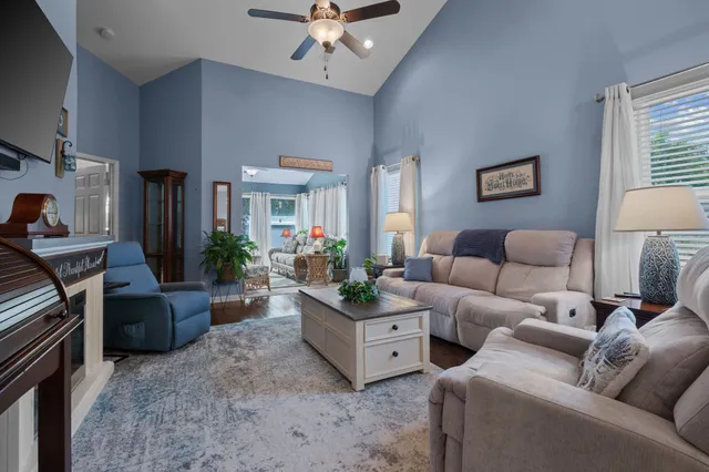 a living room with furniture and a chandelier