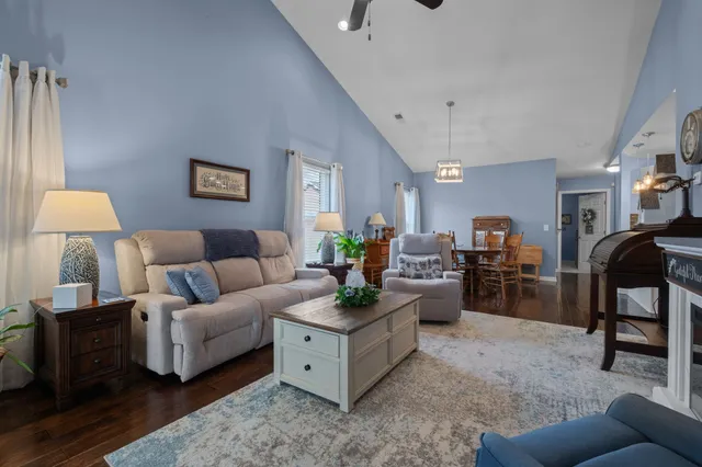 a living room with furniture and a lamp