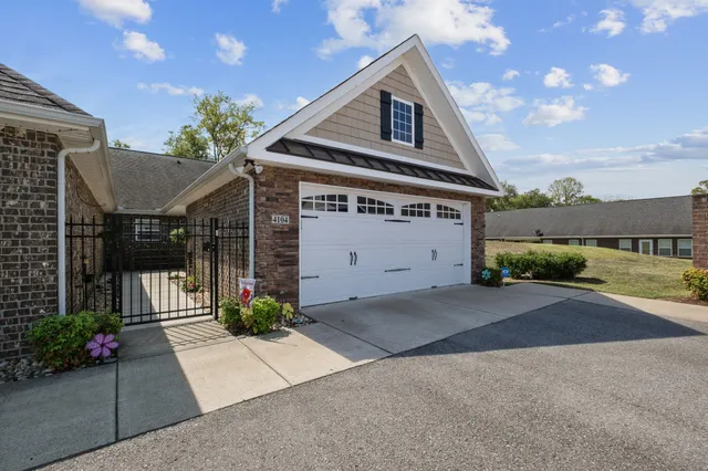 a front view of a house with a yard and a garage
