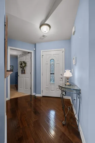 a view of a livingroom with wooden floor and furniture