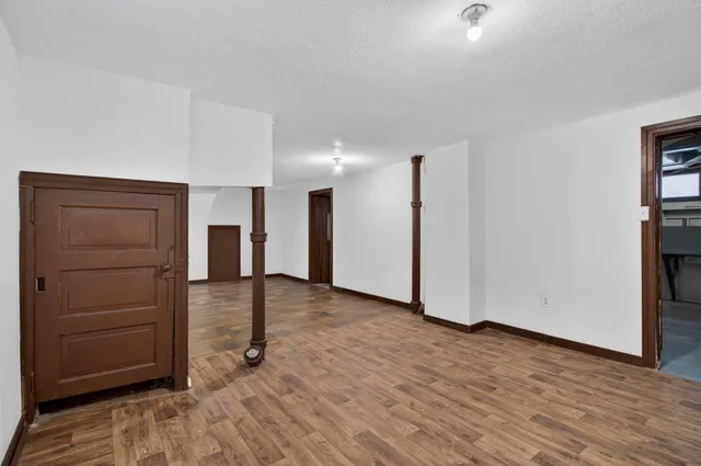 a view of empty room with closet and cabinet