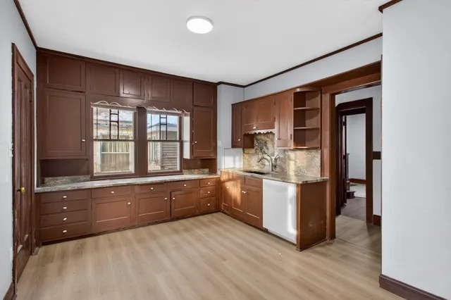 a large kitchen with stainless steel appliances granite countertop a stove and a sink